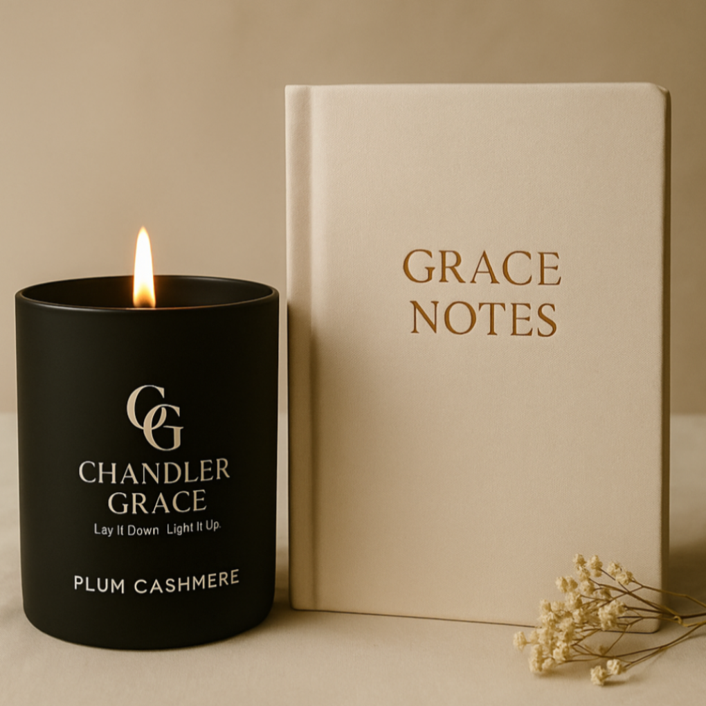 Candle and notebook with 'Chandler Grace' branding on a beige background